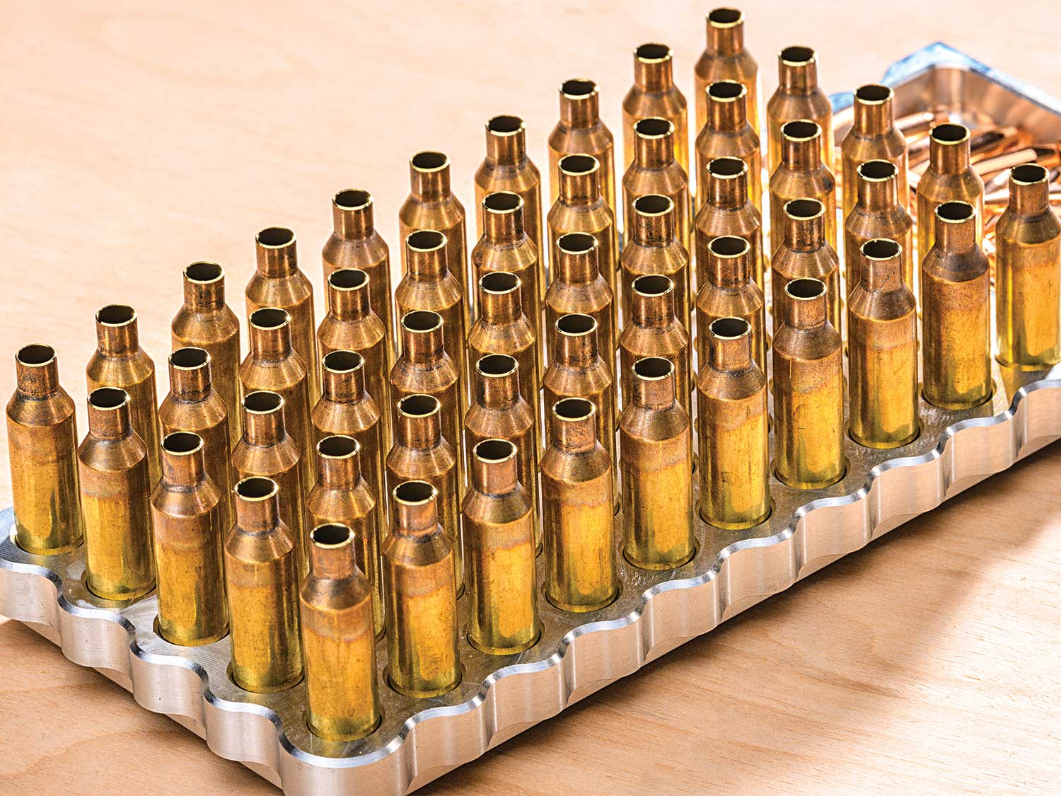 a tray of new brass ammo cartridges