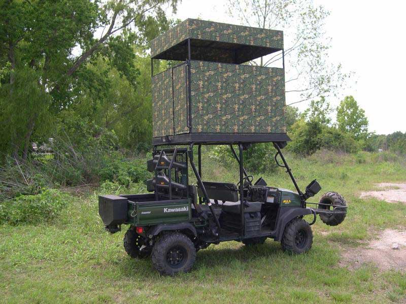 a critter gitter UTV with a rooftop hunting blind on top of it