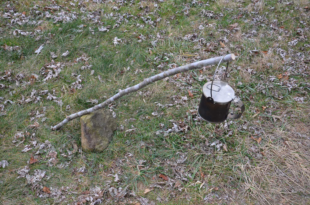 single stick holding a cookfire pot