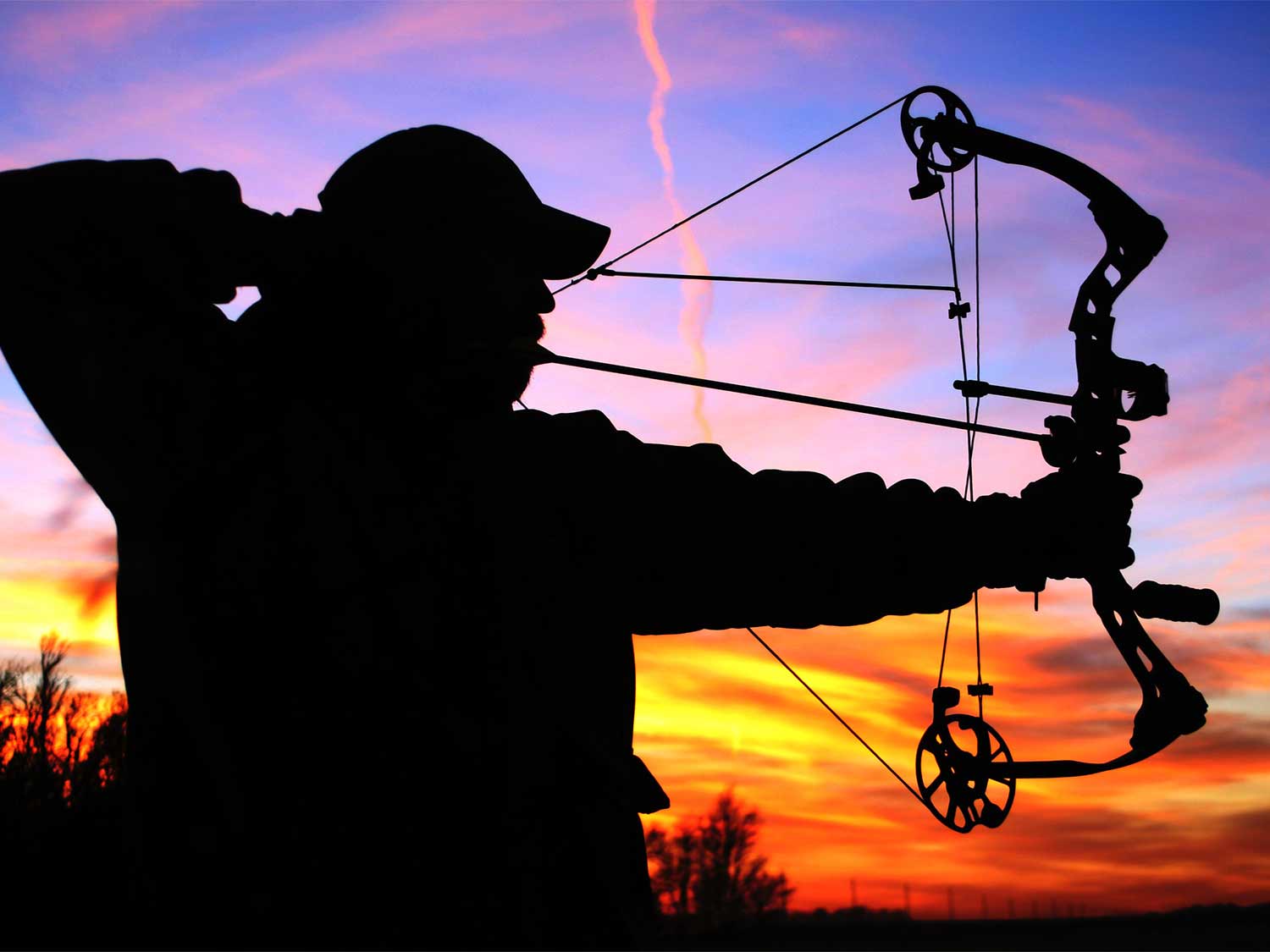 silhouette of a bowhunter aiming a compound bow