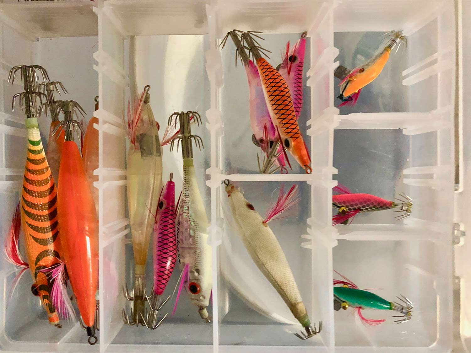 a tackle box of squid lures