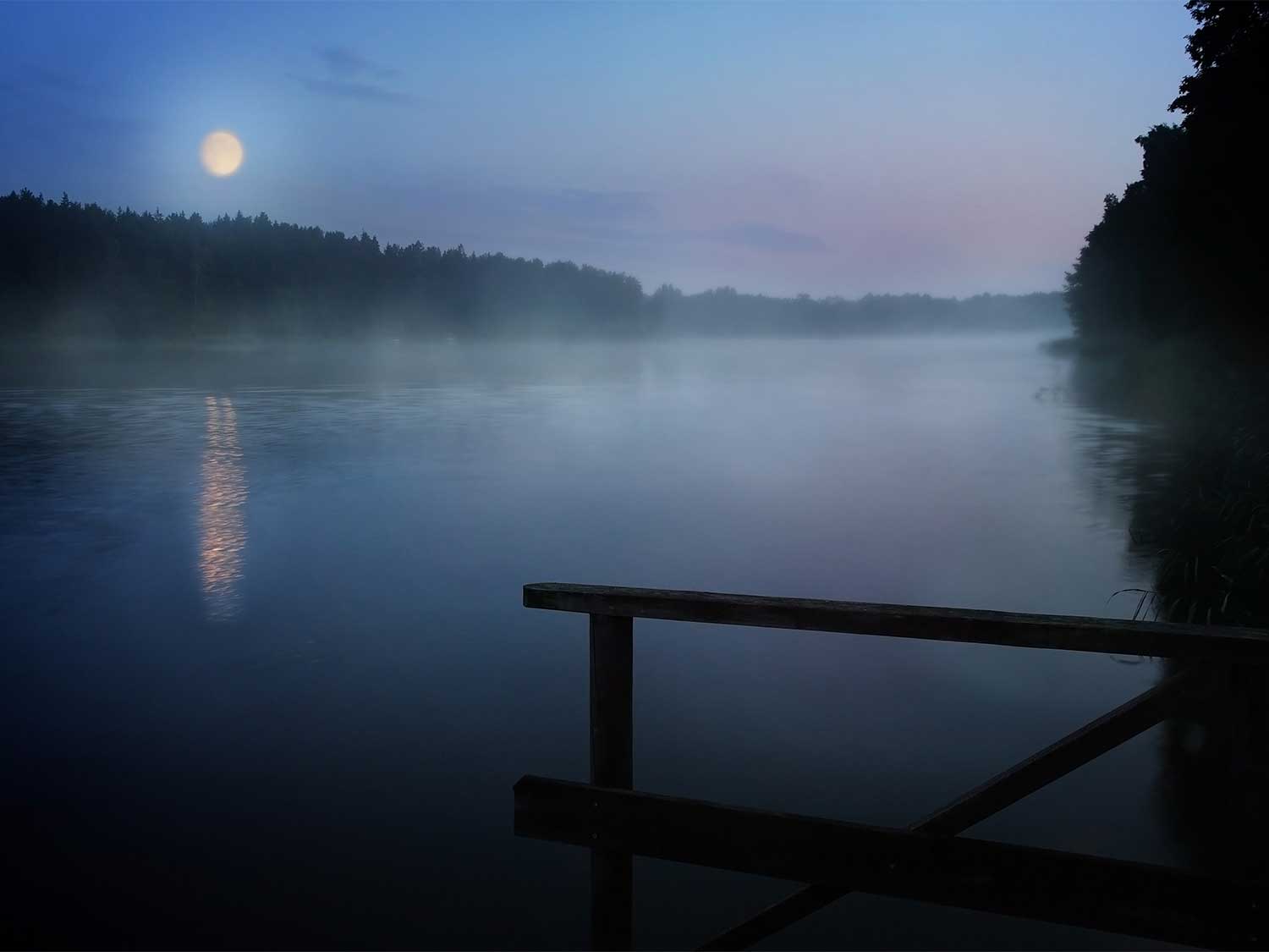 moon reflecting against a lake at night