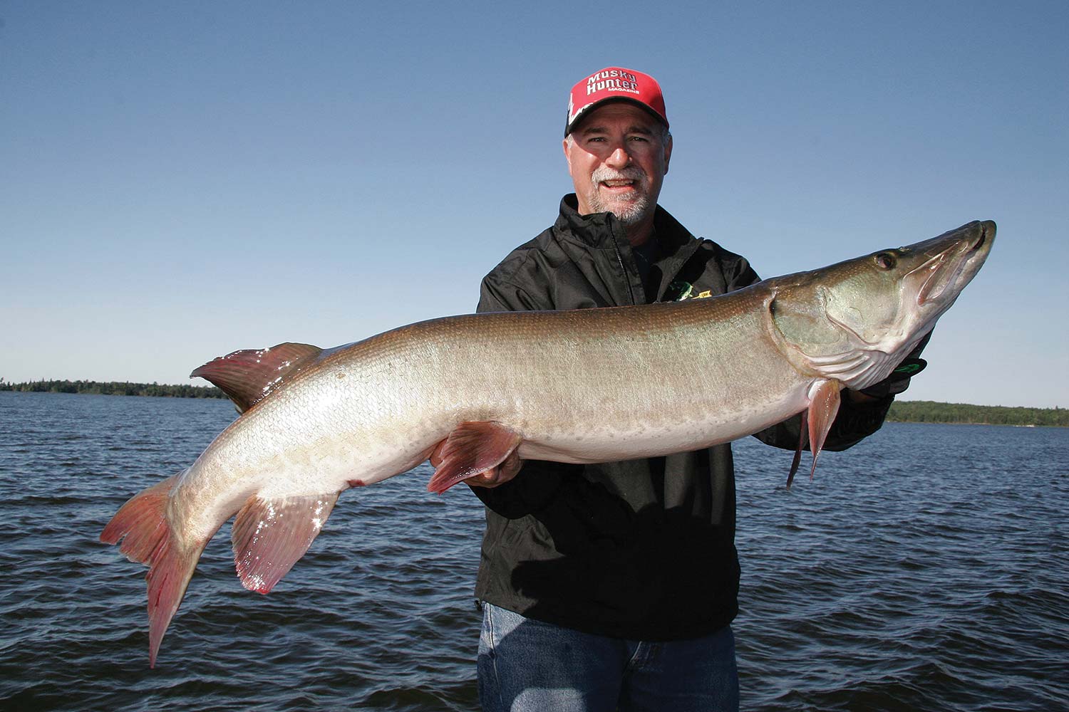 kevin schmidt holding a giant muskie