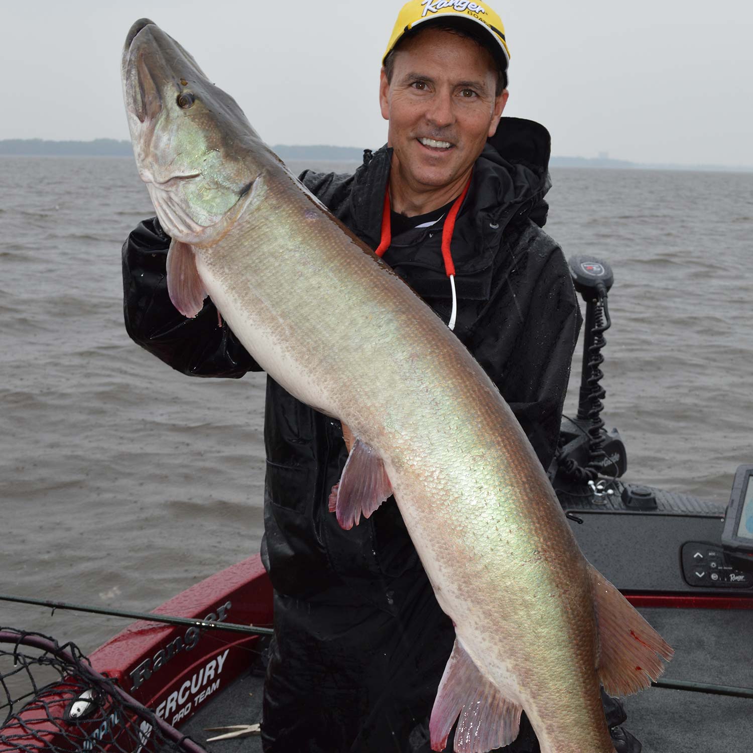 jim saric holding up a giant muskie