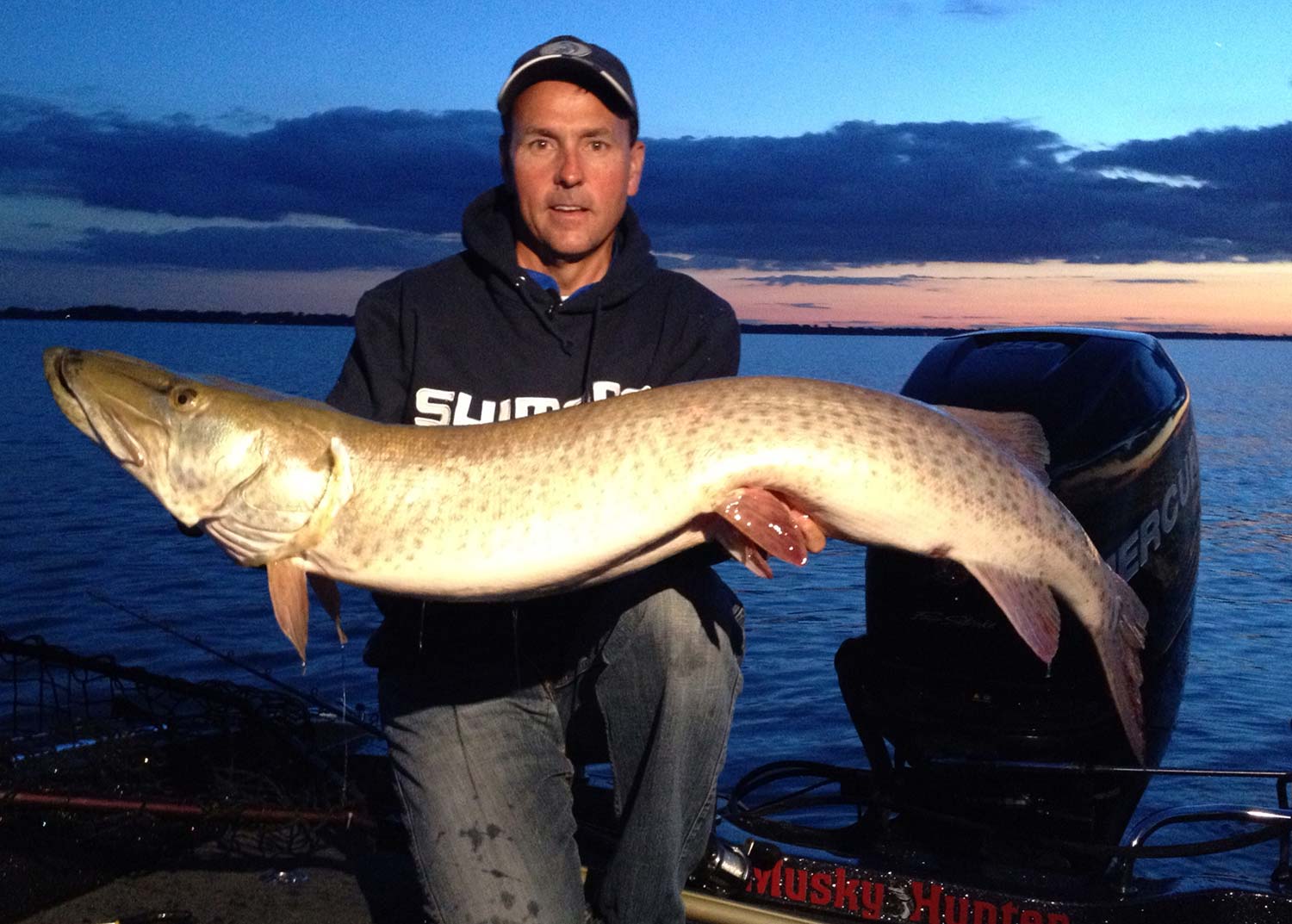 jim saric holding up a giant muskie