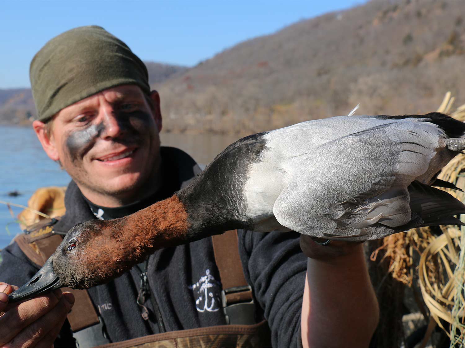 hunter holding up canvasblack duck