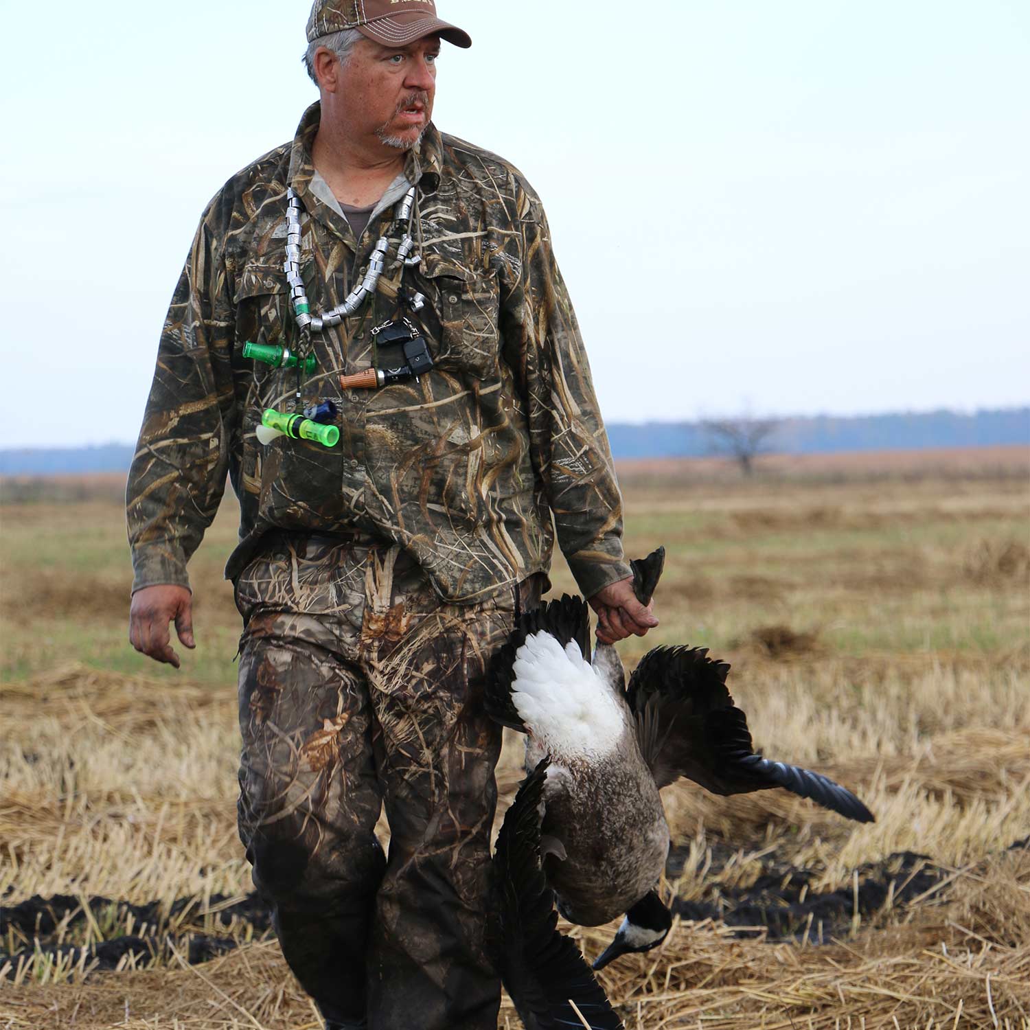 hunter carrying a canada goose