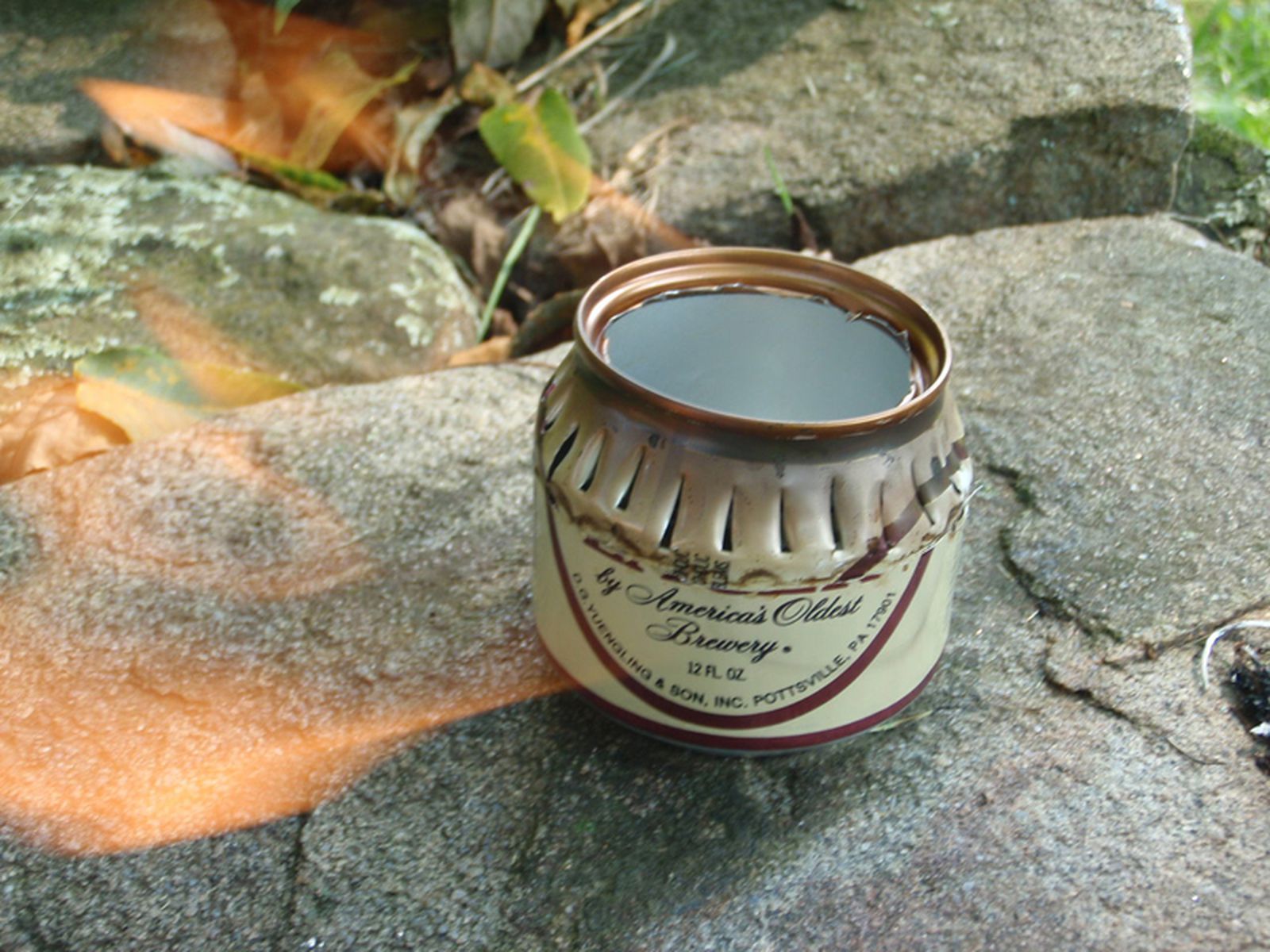 A lighted beer can emergency stove.