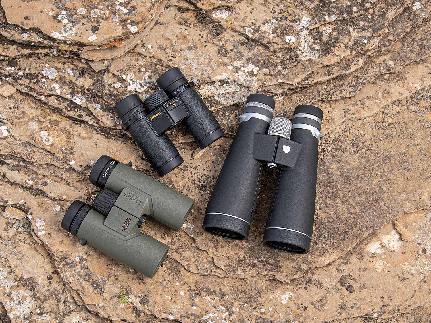 three binoculars on a stone ground