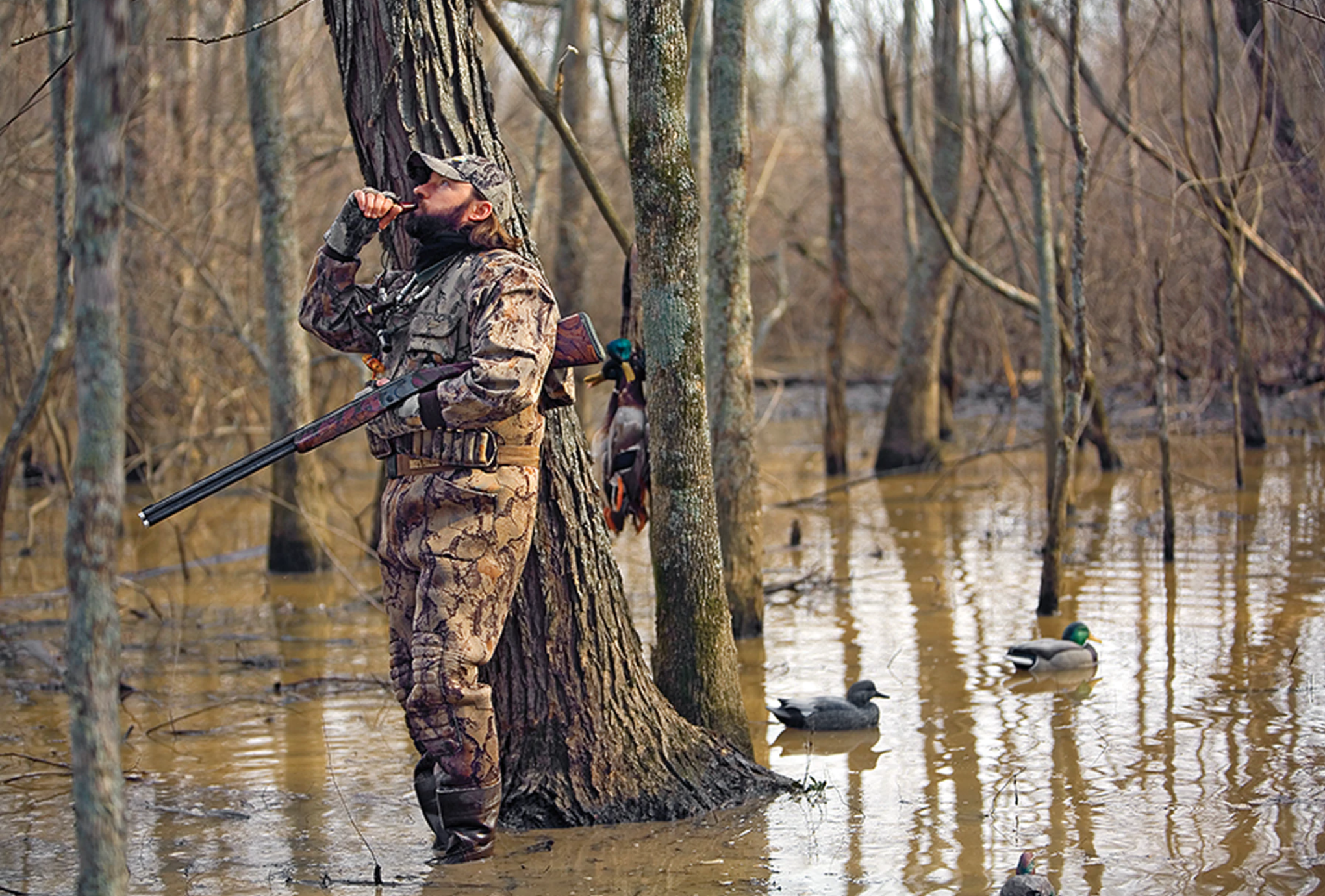 A waterfowl hunter calls in the next group of birds.