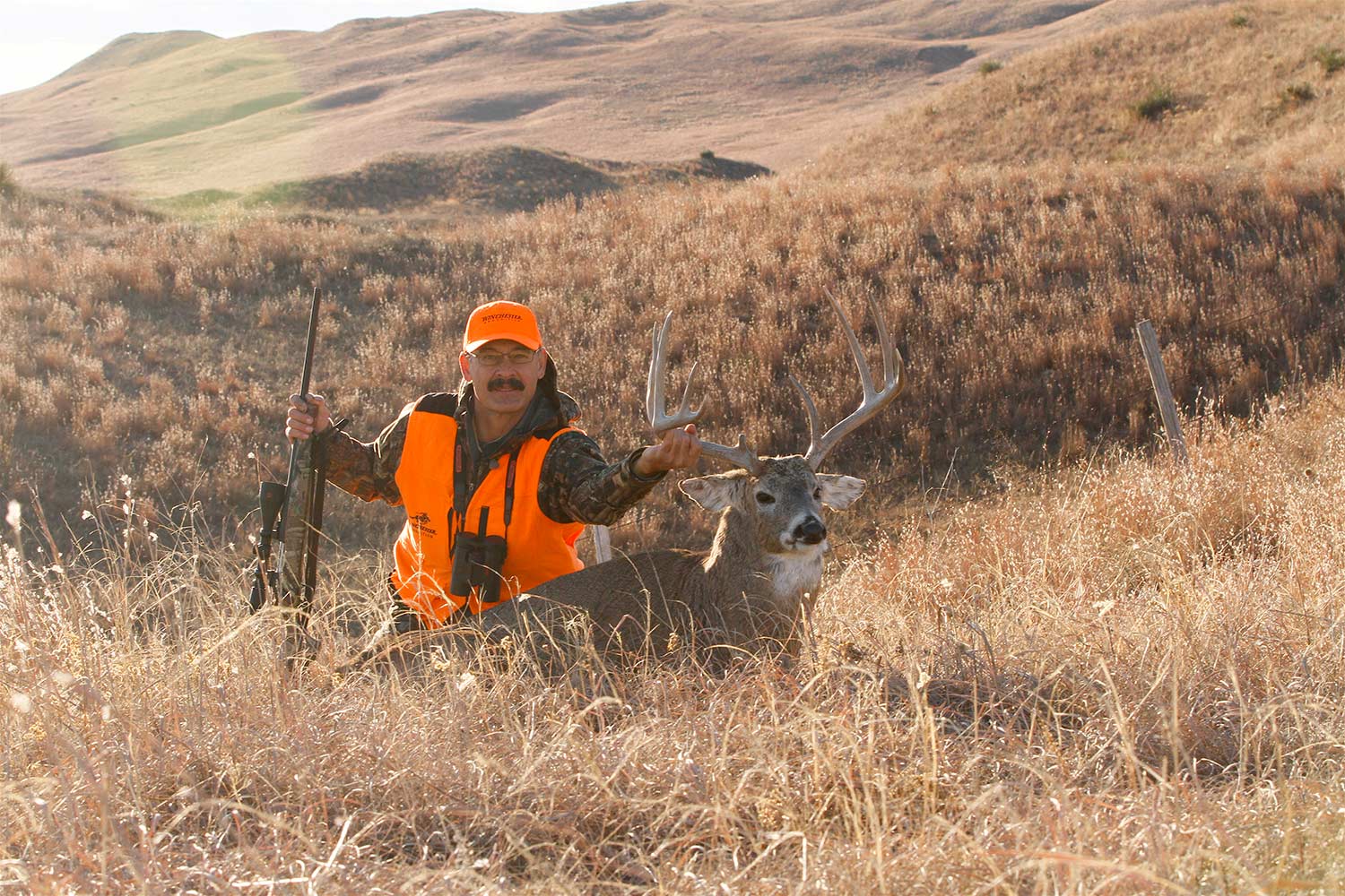 whitetail deer hunter with Mossberg ATR bolt-action