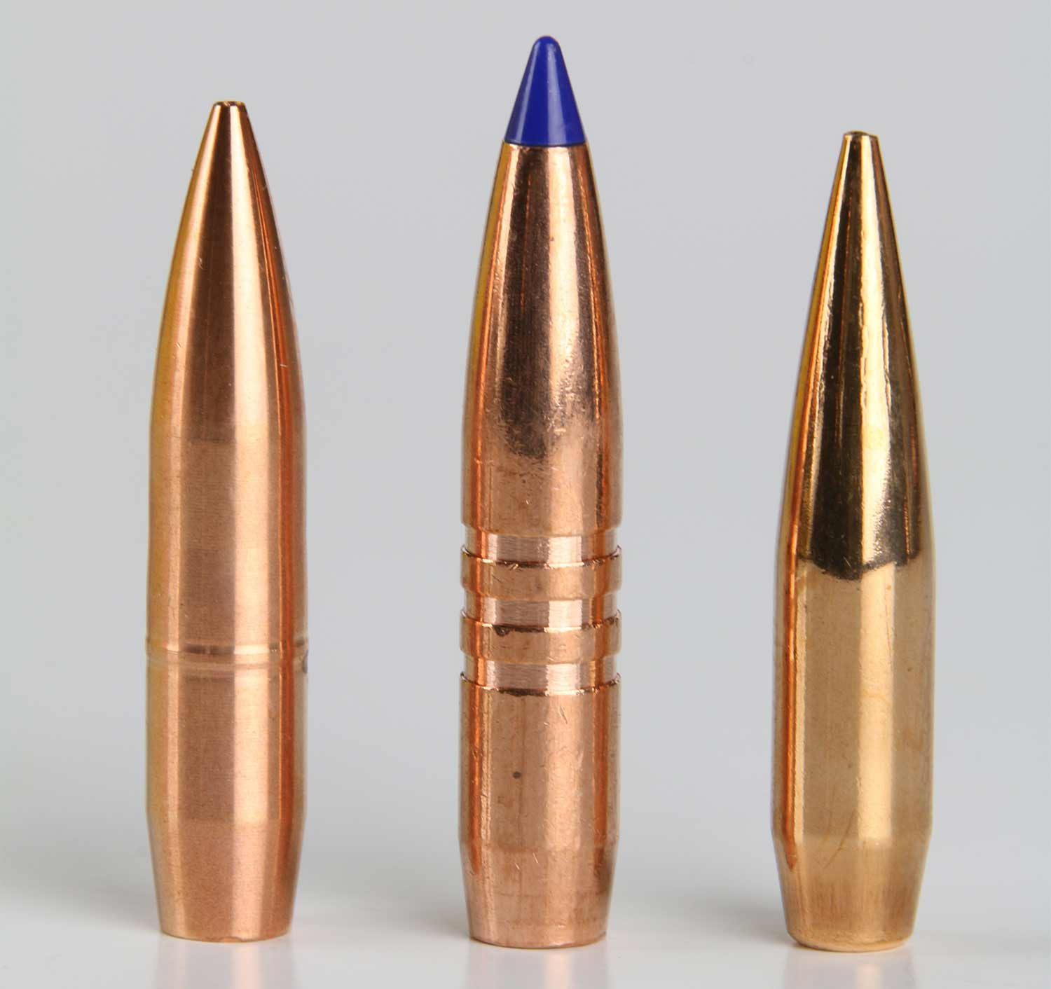 a lineup of bullets on a grey background