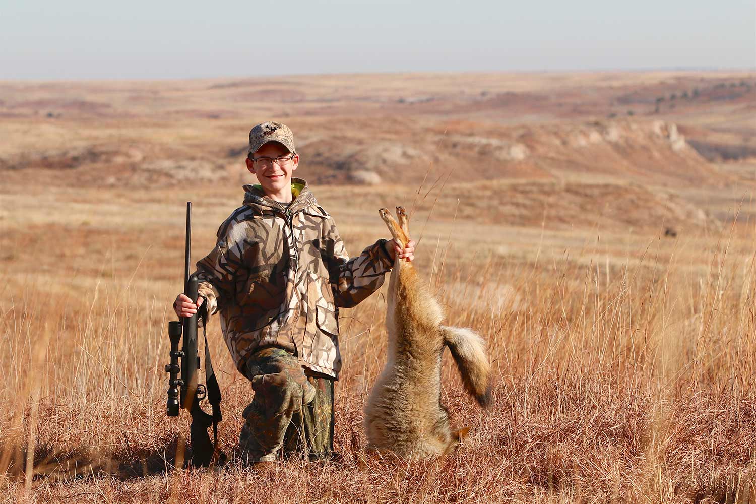 A young hunter with a coyote