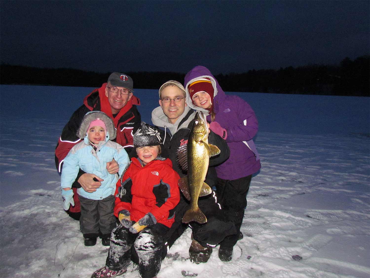 a family ice fishing with rattlebaits.