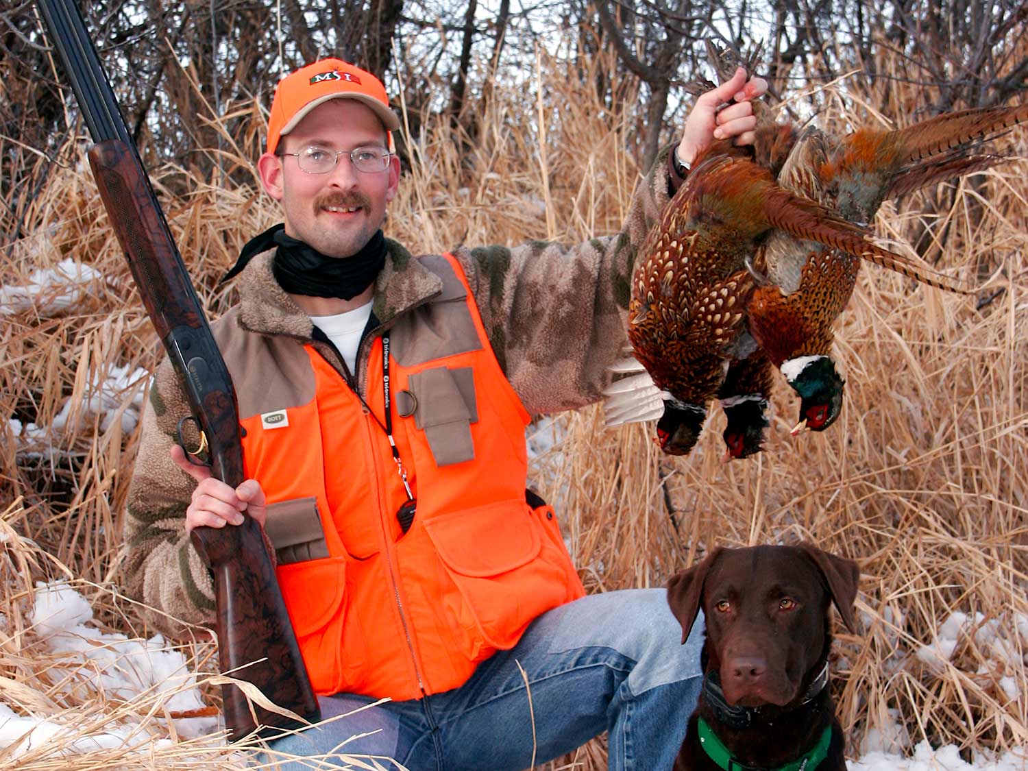 Hunter holding up a pheasant.