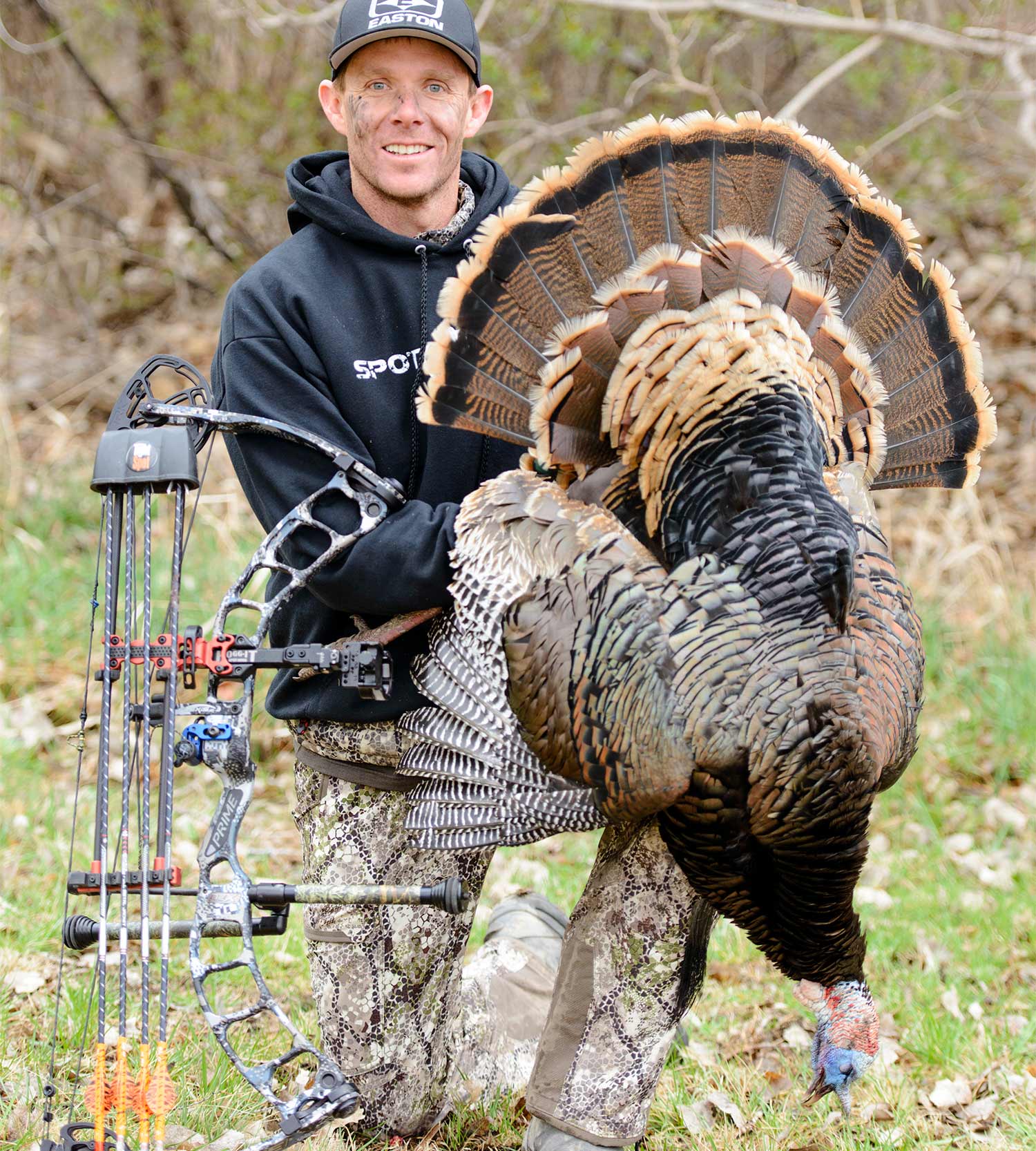 A hunter holding up a Nebraska spring turkey.
