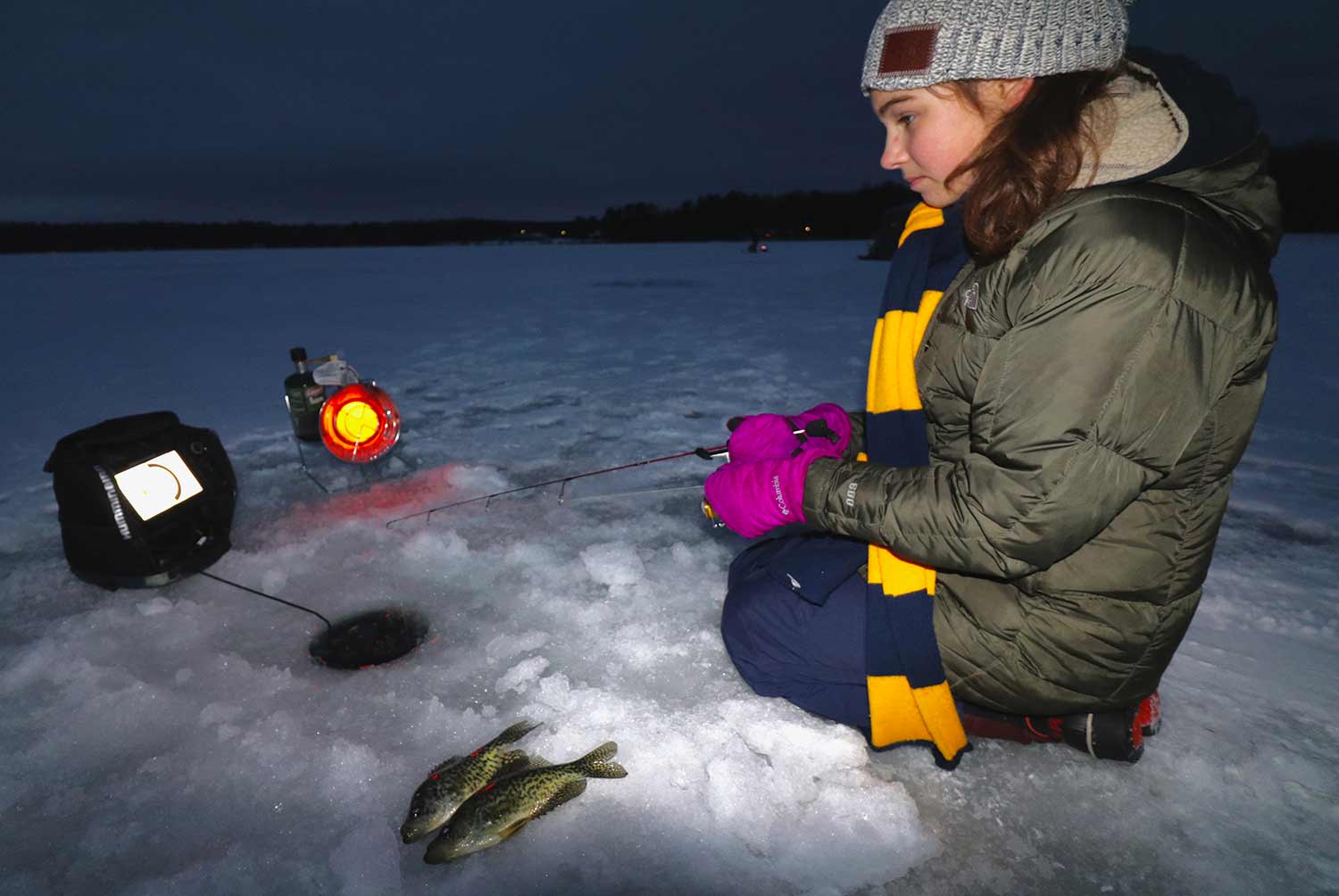 young girl ice fishing.