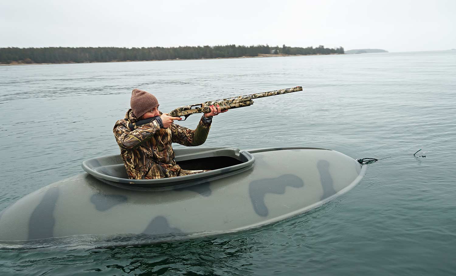 Hunter in a hunting boat hunting waterfowl.