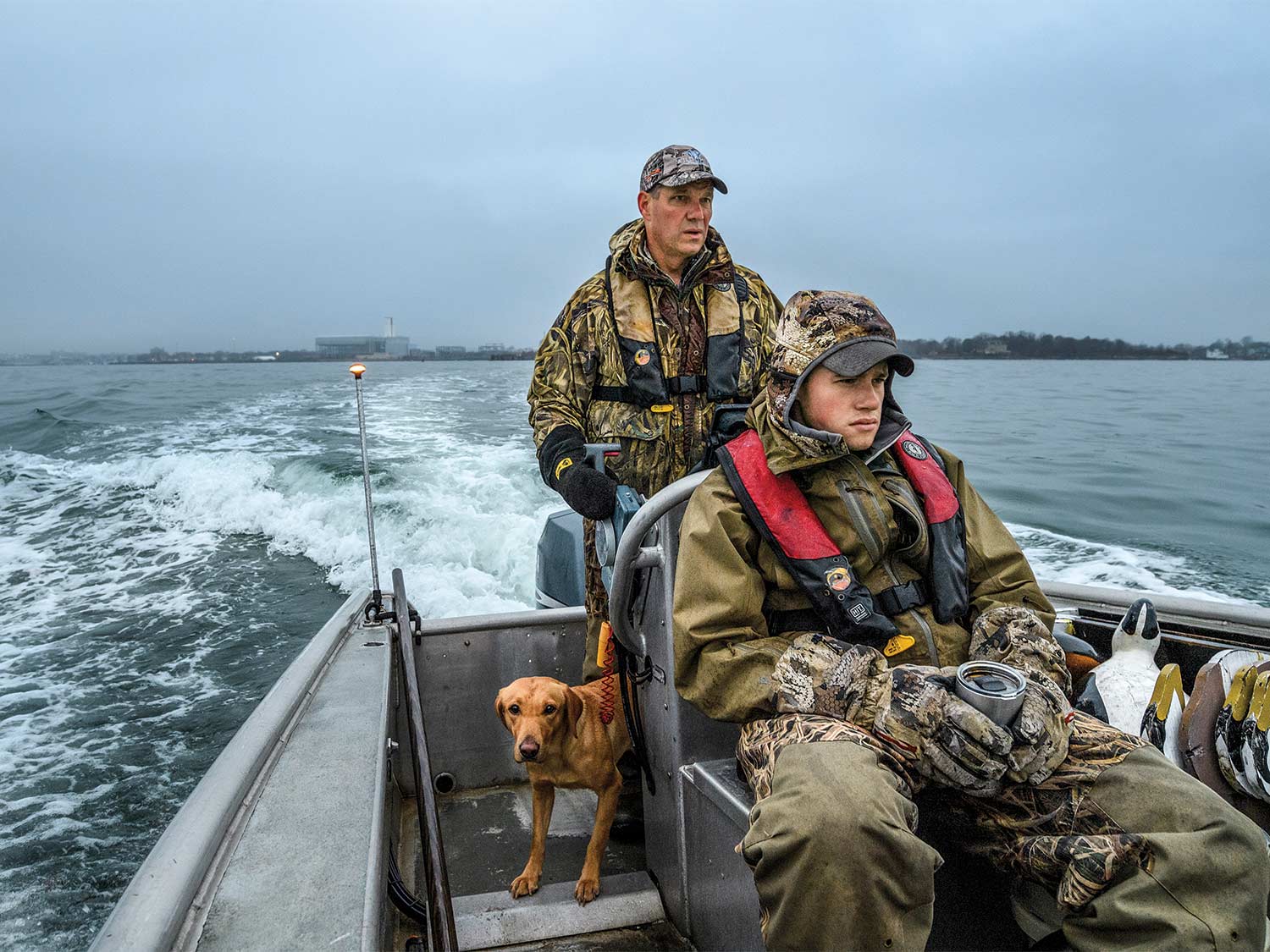 Two hunters in a duck boat hunting eider.