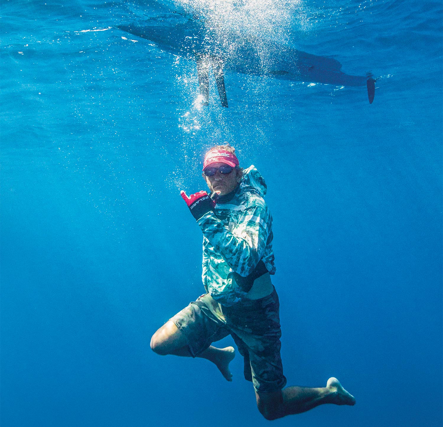 Underwater image of Lance Clinton celebrating a day of fishing.