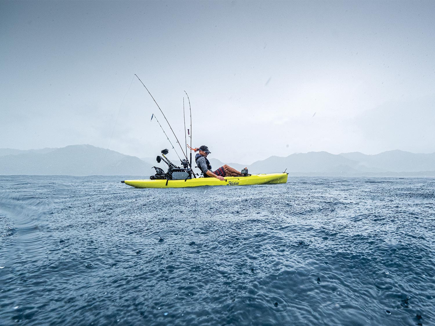 Lance Clinton fishing in a rain squall off Costa Rica.