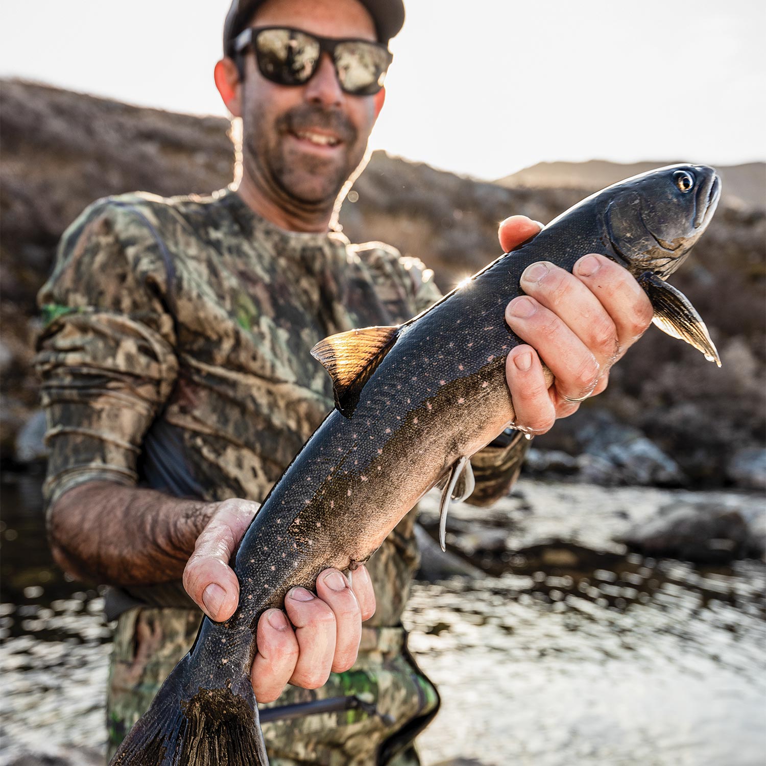 Andrew McKean holding up an arctic char.