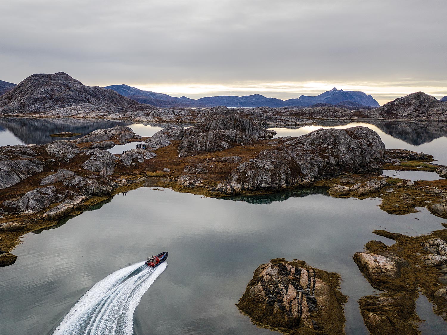 A lone boat in a sound of Greenland.