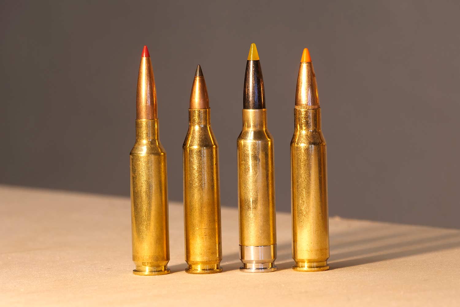 A lineup of 4 rifle ammo cartridges.