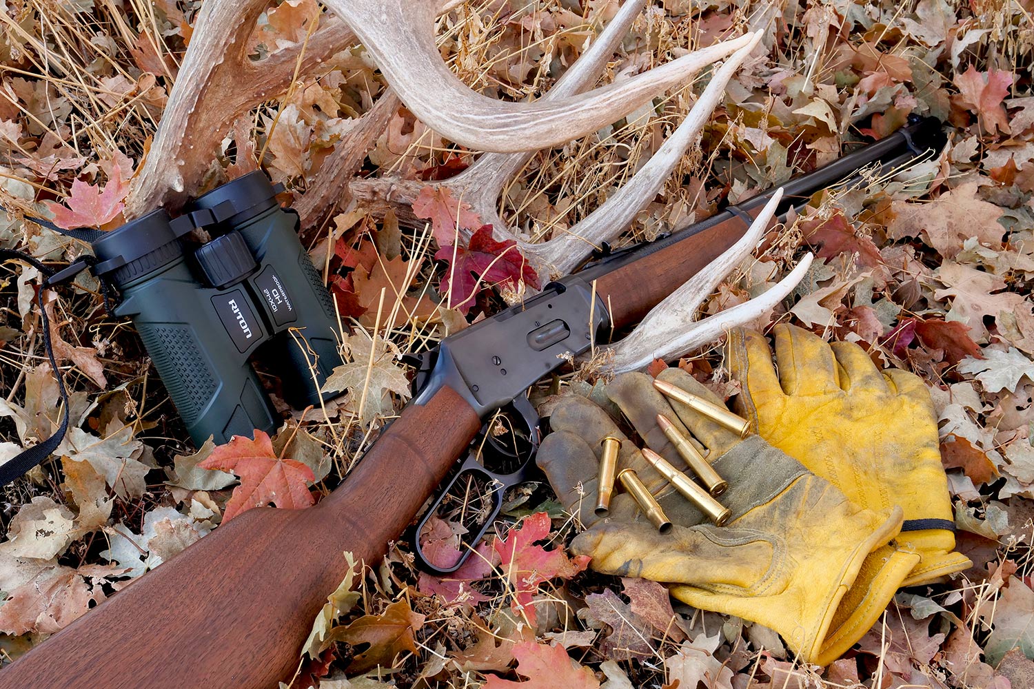 Hunting gear and a .30-.30 lever-action brush rifle.