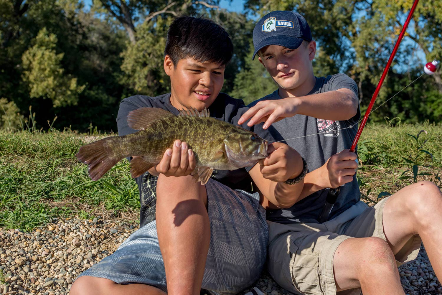 Two boys fishing bass at Lake St. Clair