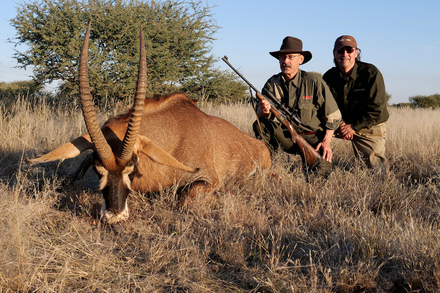 hunter next to an African pronghorn antelope.