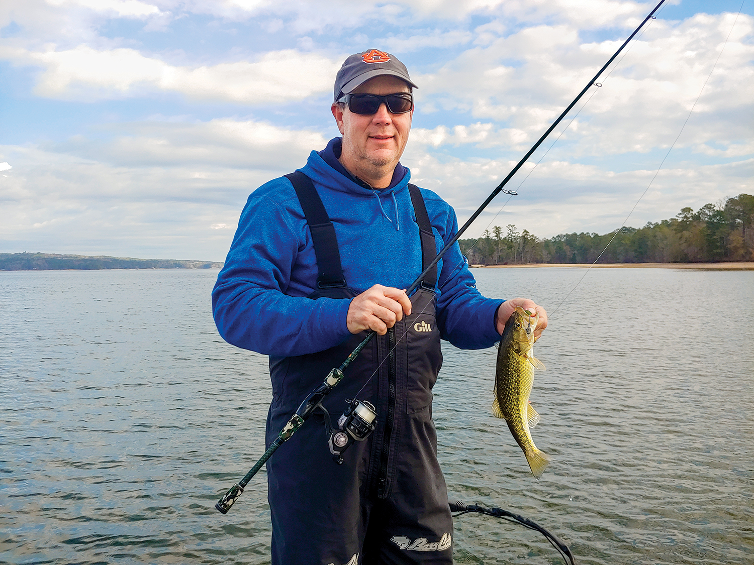 Angler holding a large Lake Martin bass.