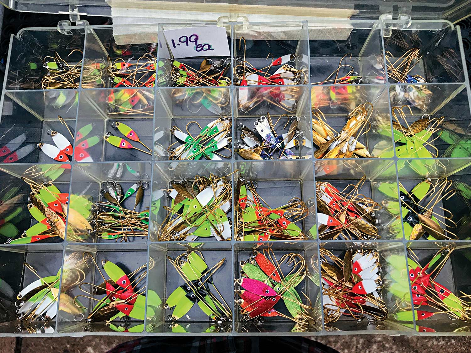 A box of hand-painted flutter spoon lures.
