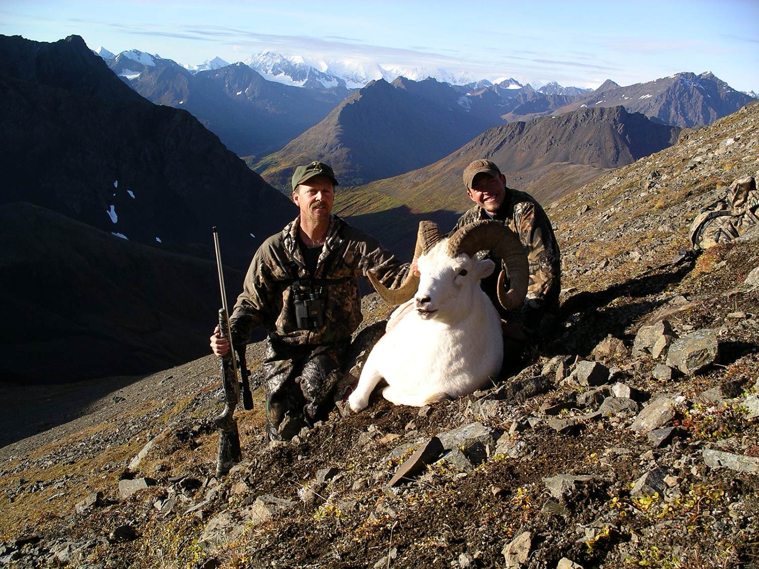 Two hunters with a dall ram.