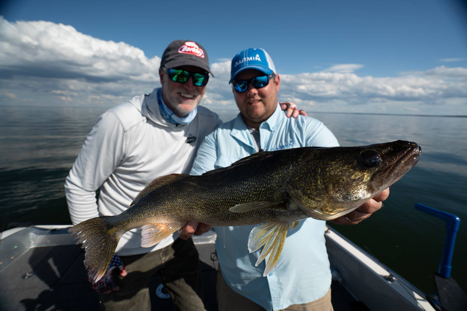 Angler holding a large walleye beside Steve Pennaz