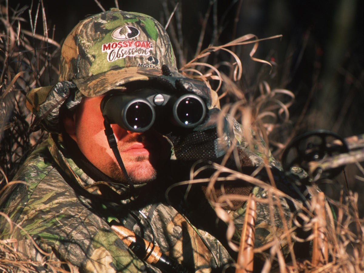 A hunter glassing through binoculars.