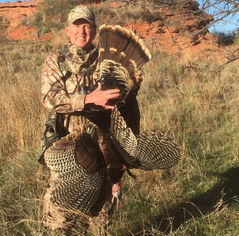 Hunter holding an Oklahoma turkey.