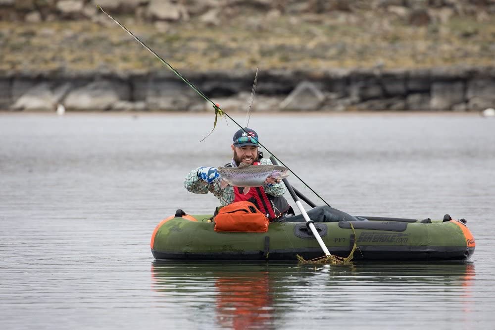 man fishing in an inflatable boat