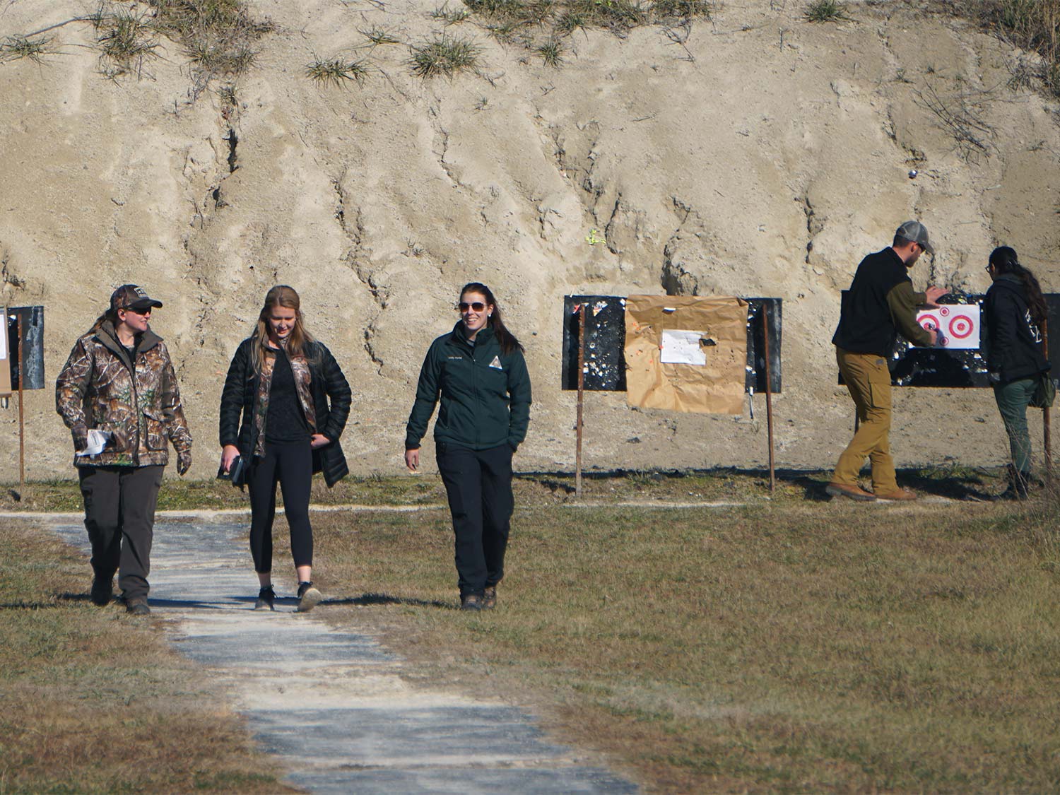 Women walking at a gun range.
