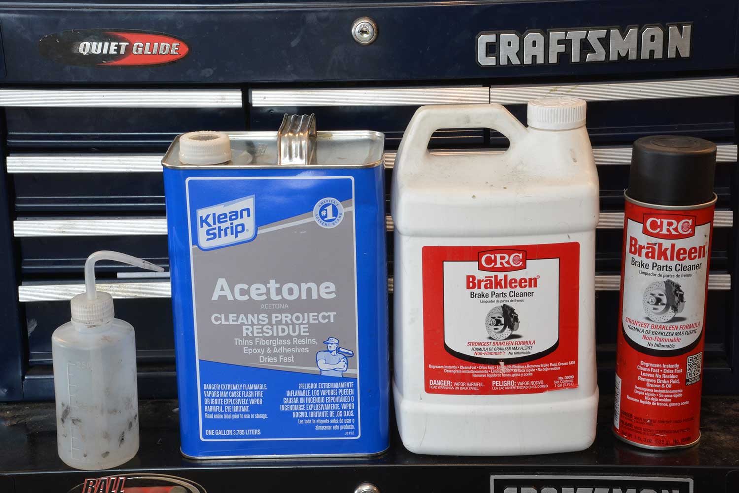 Two containers of Acetone and Brakleen.
