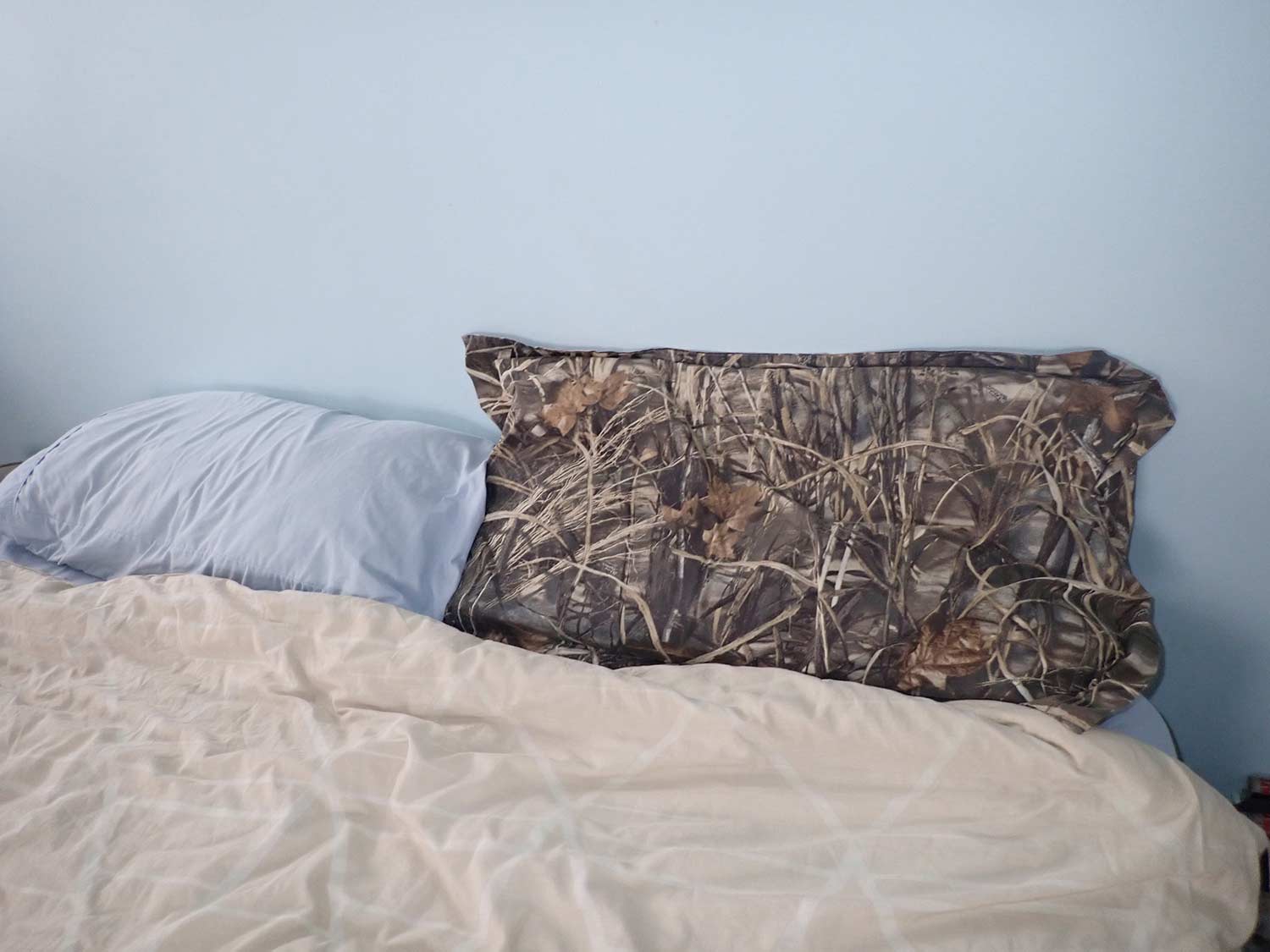 A camoflauge pillow case stuffed with waterfowl down.