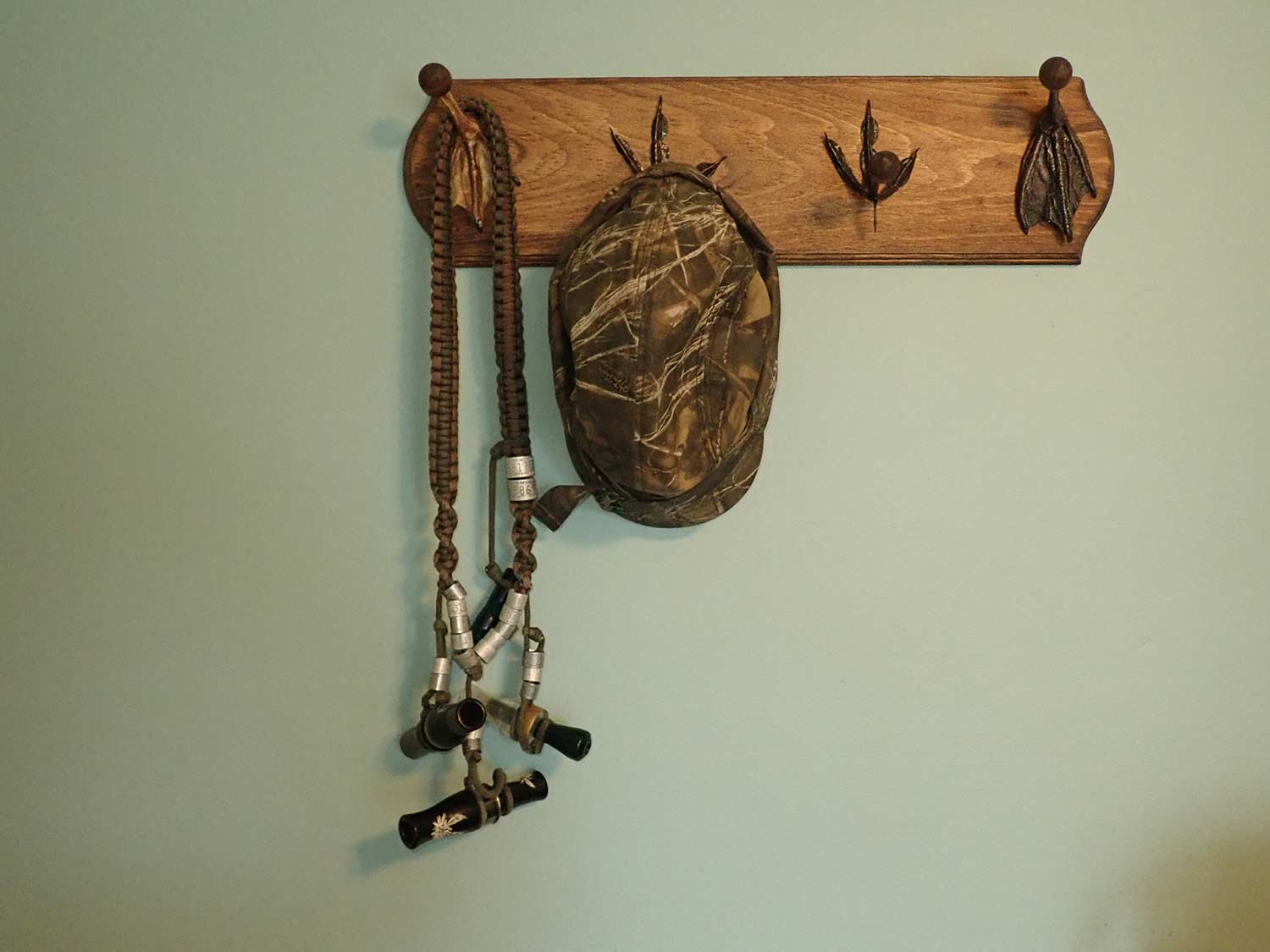 A wall-hanging hat rack made with duck feet.