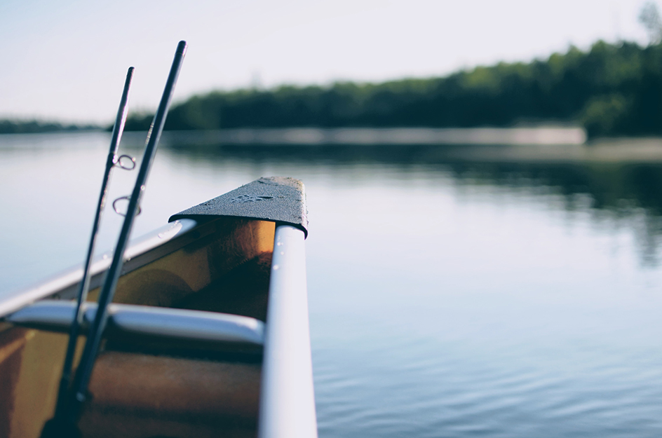 boat in water with fishing rod