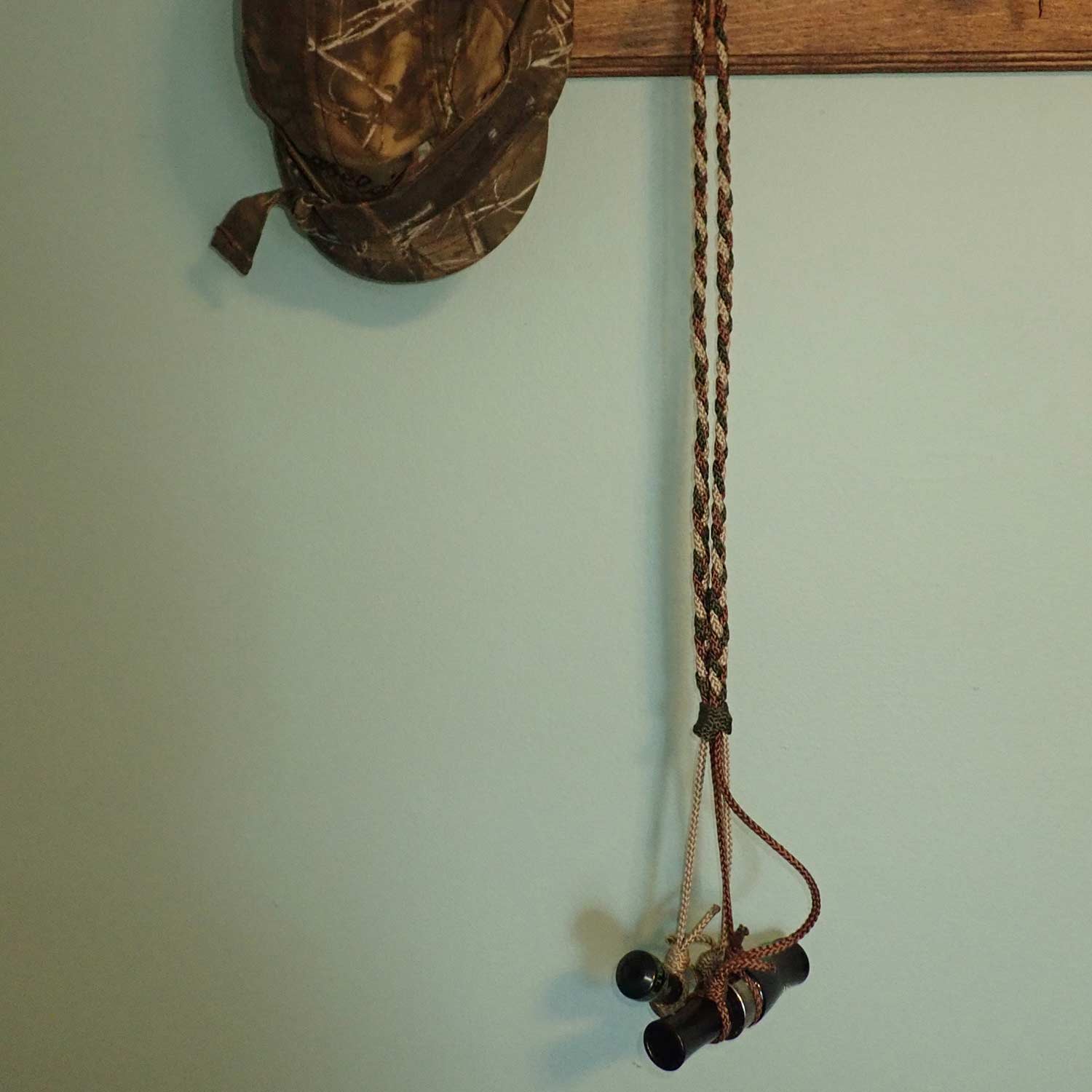 A duck call hanging from a lanyard.