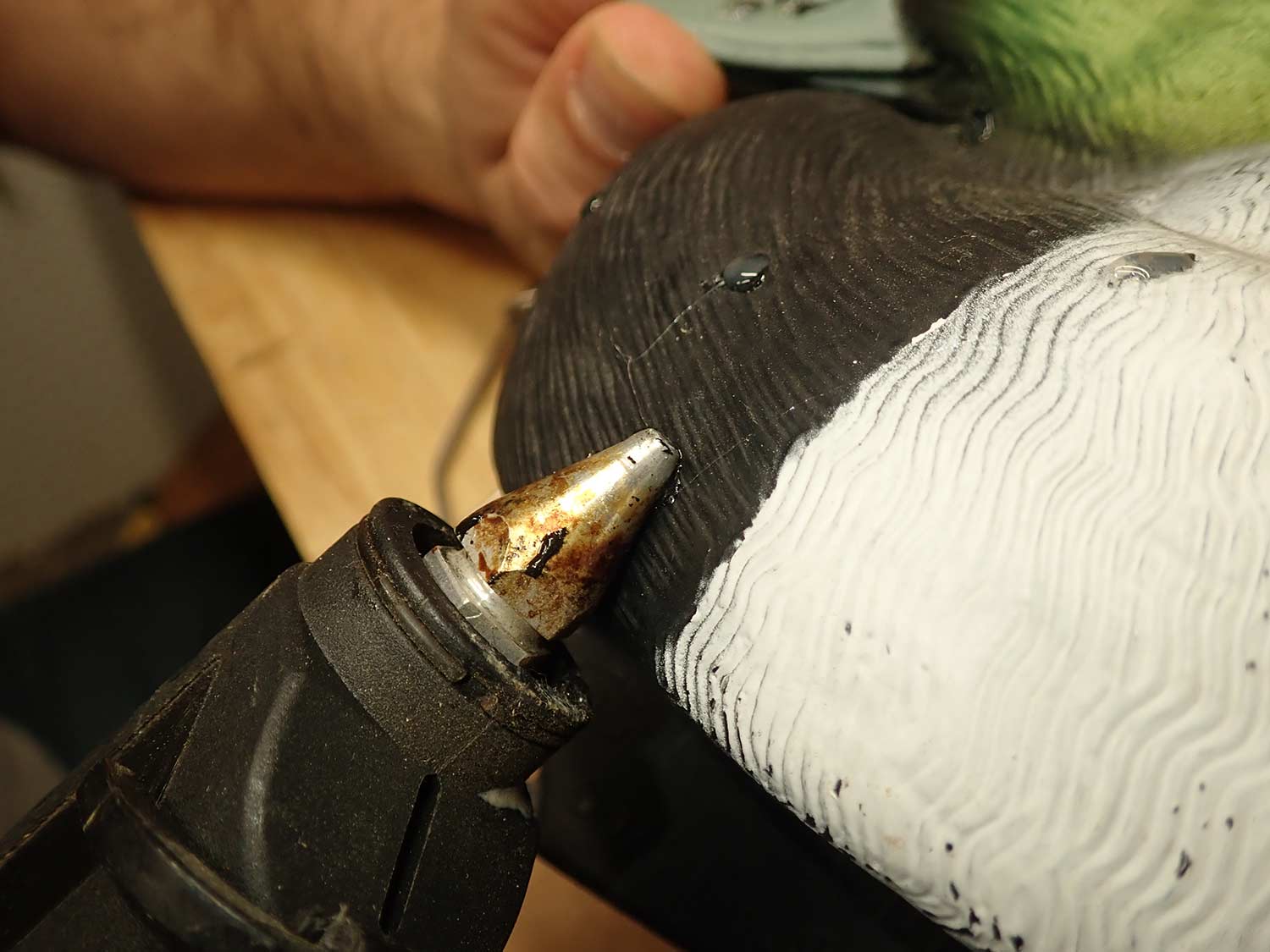 Hot glue gun being used as a decoy repair.