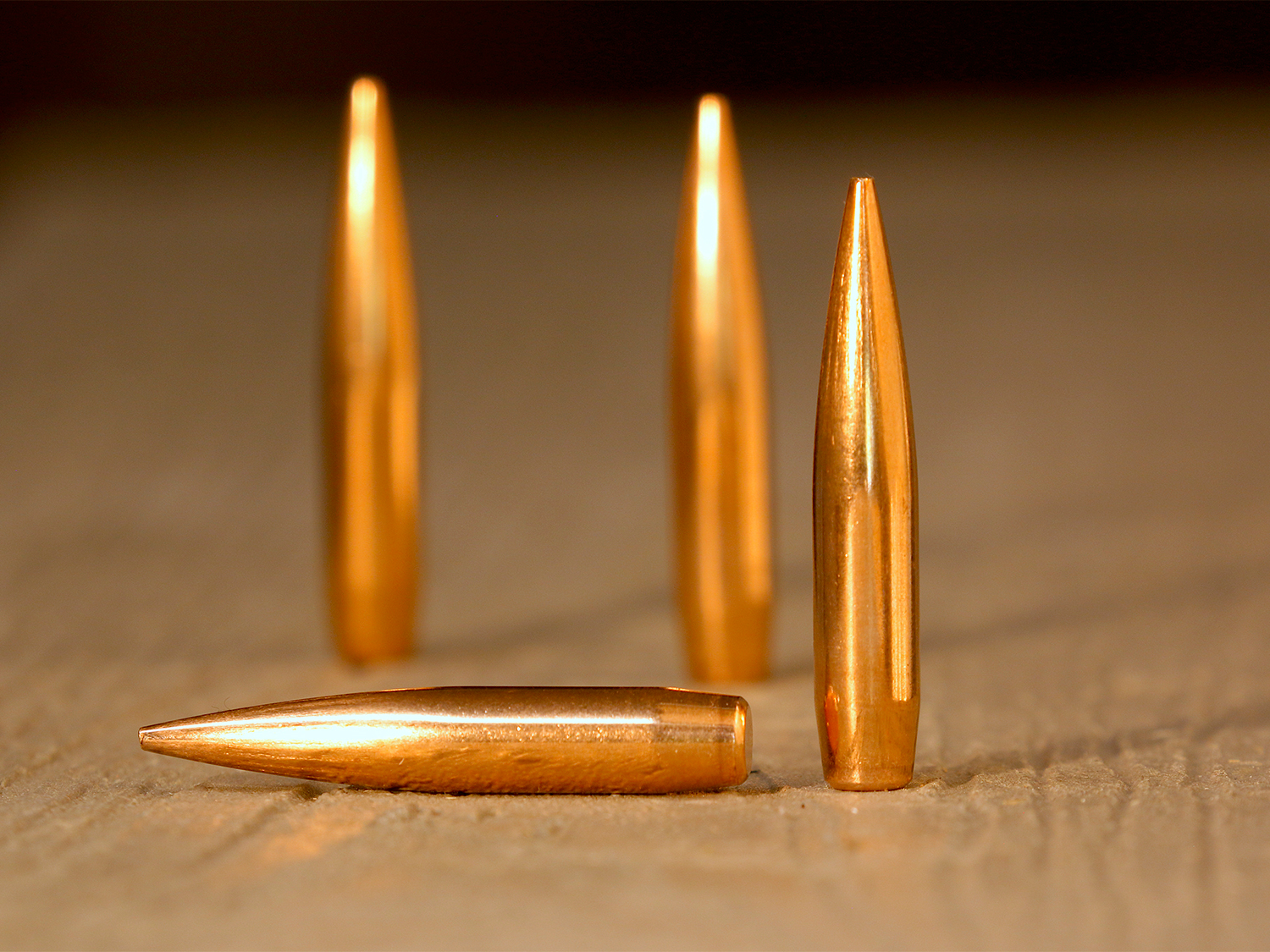 Several rifle bullets on a table.