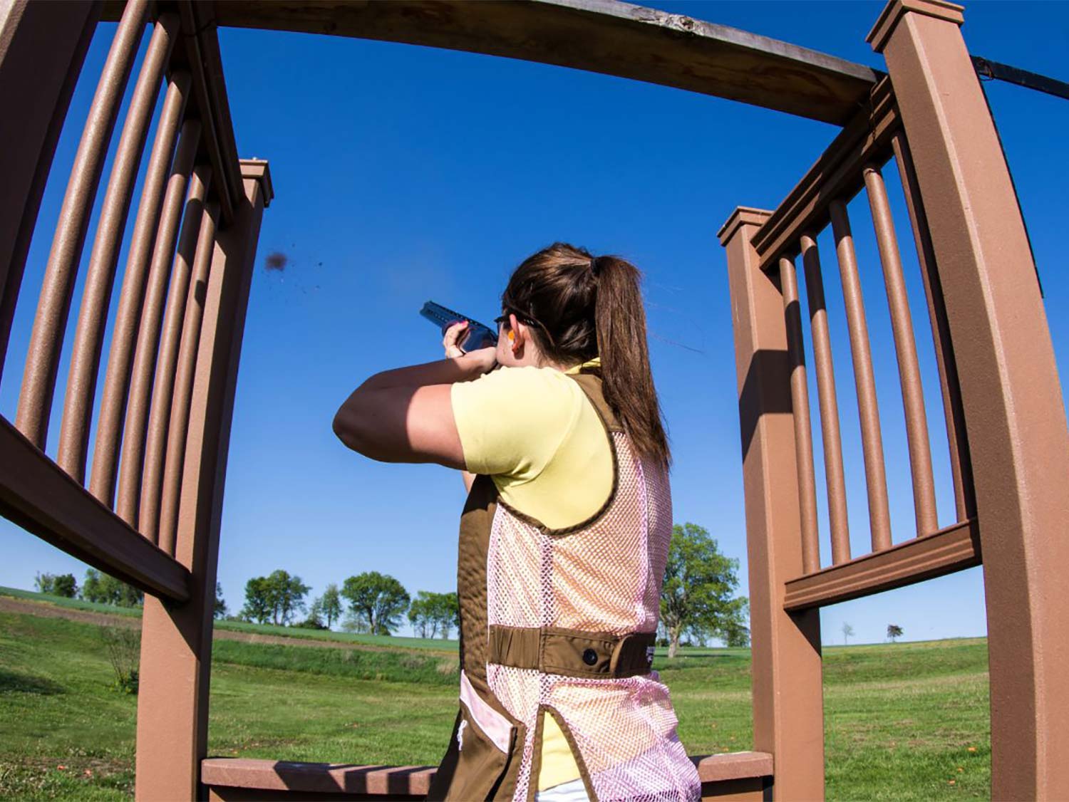 A woman shooter at a range while shooting skeet.