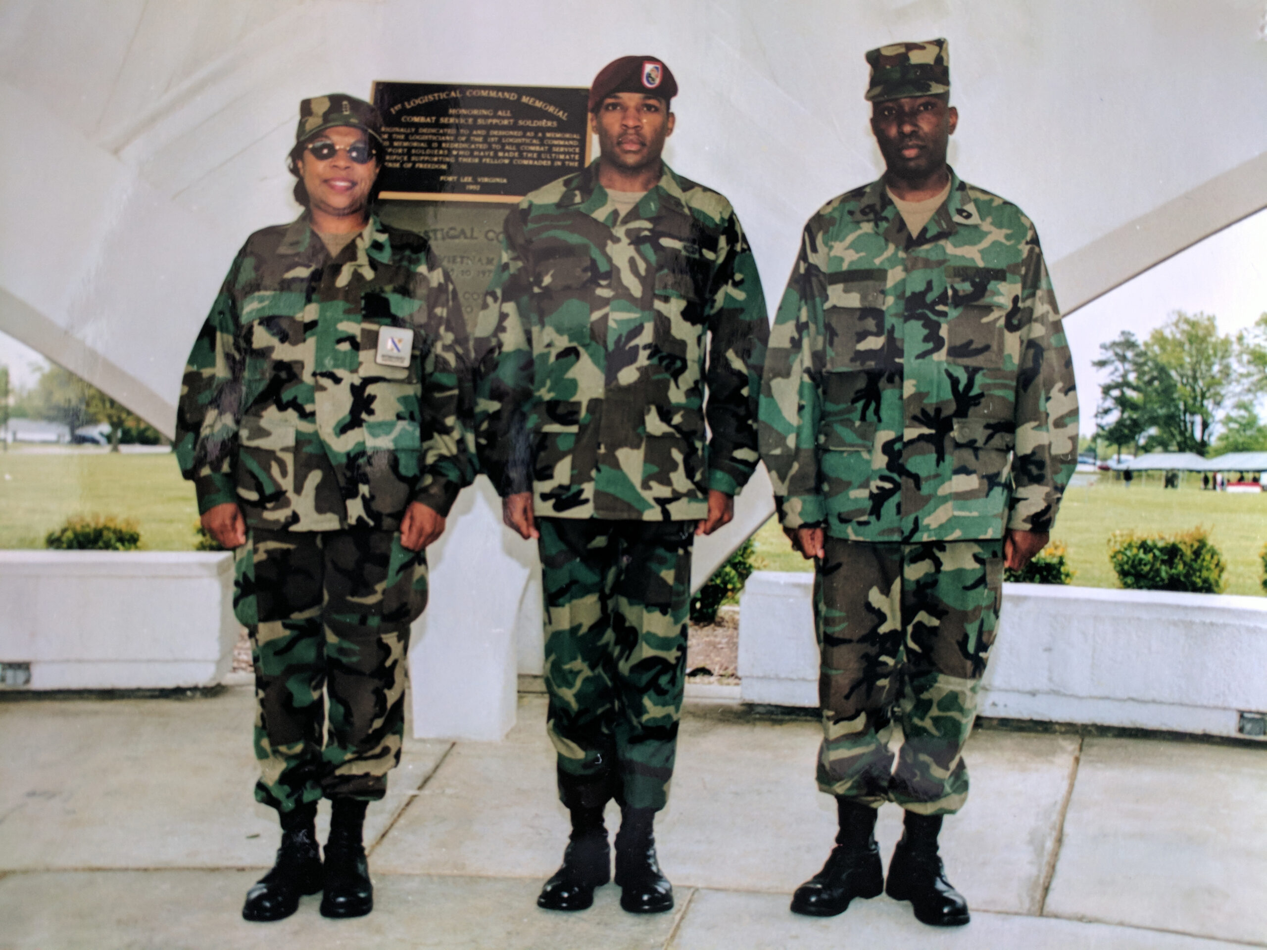 A mother, father, and adult son in army fatigues, standing at attention in Fort Lee, Virginia.