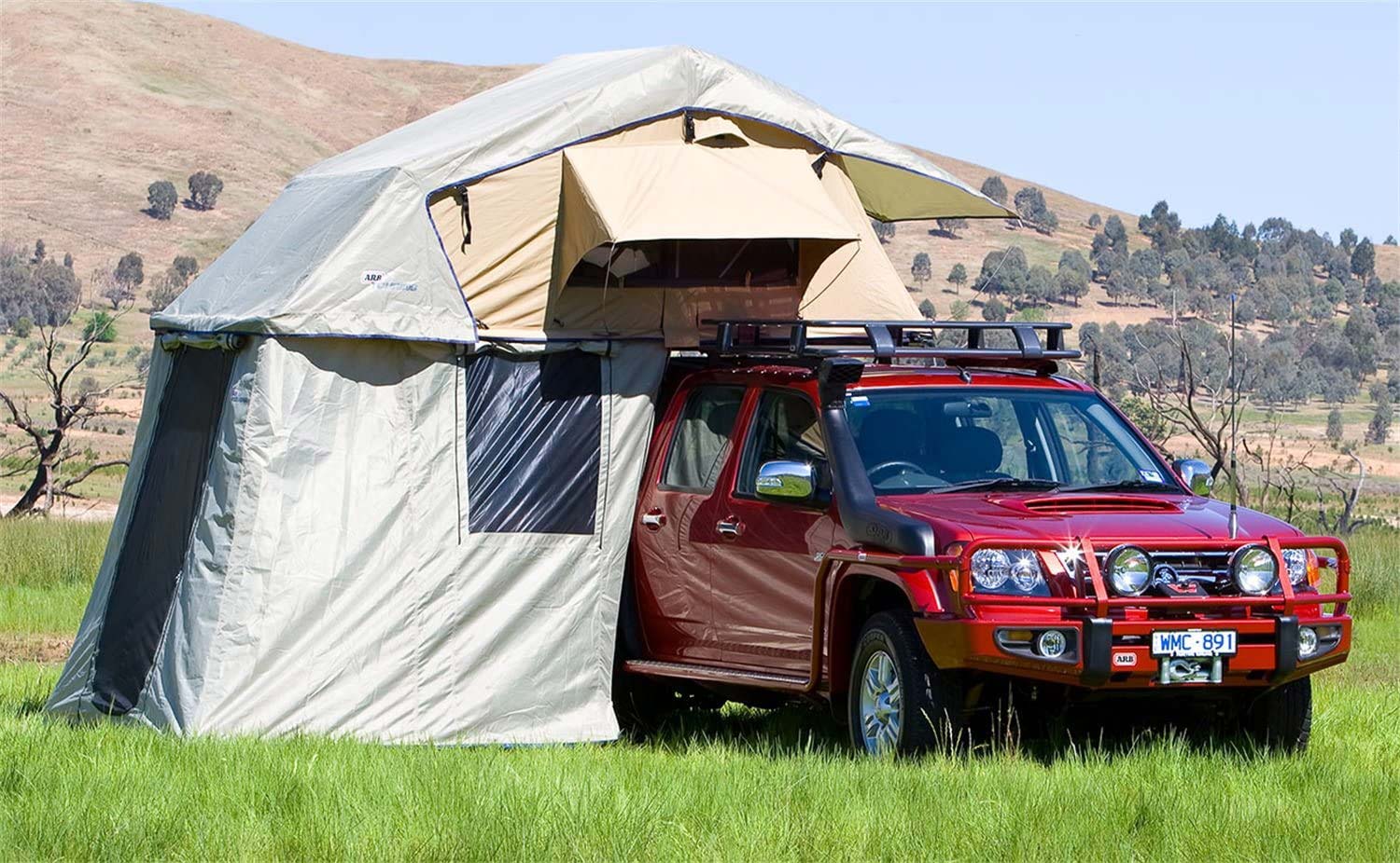 A red outdoor vehicle with a camping tent attached to it.