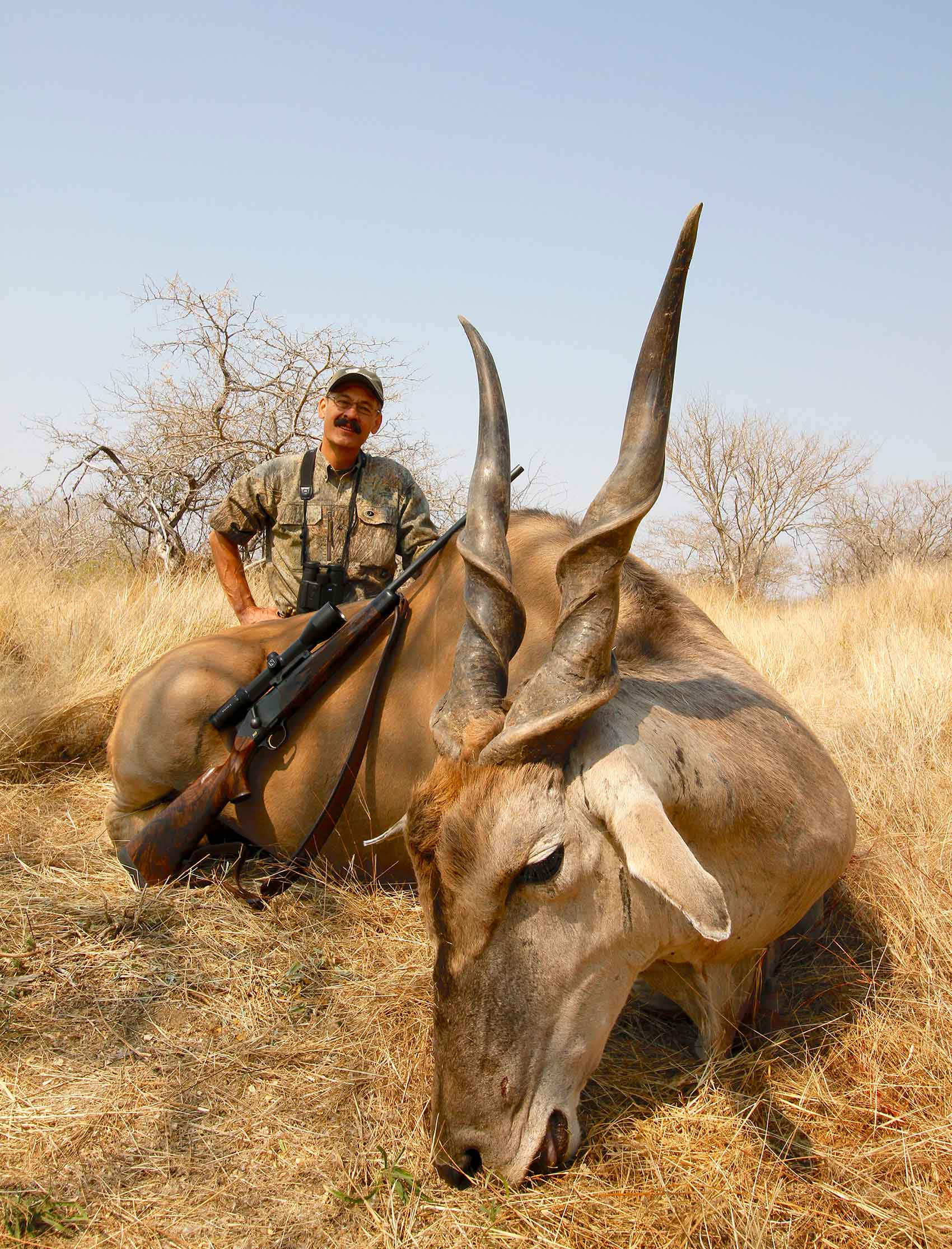 Hunter standing beside a recently killed 1,800-pound Namibian eland